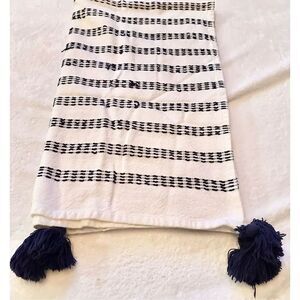 Navy and white stitched towel with Pom Pom’s